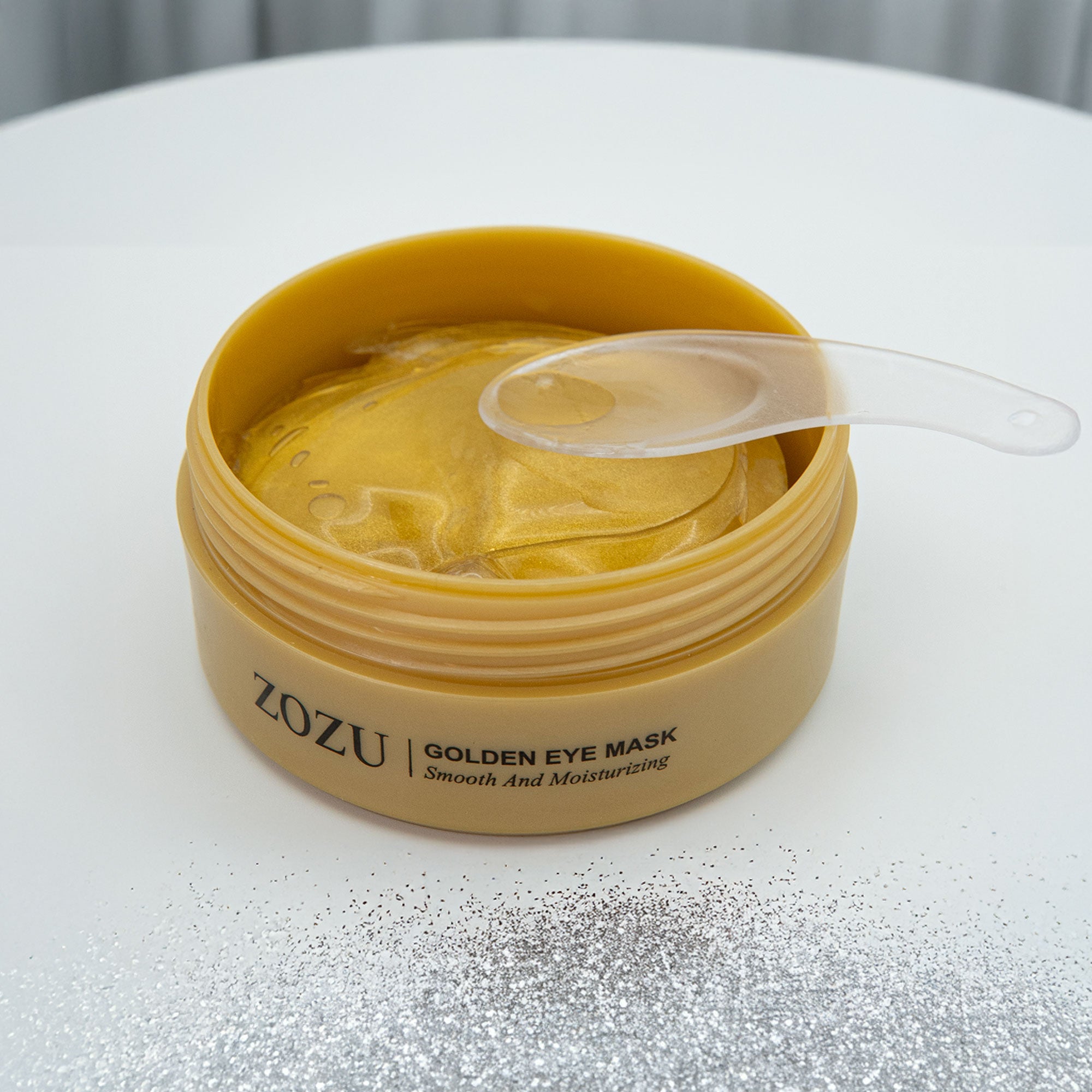 ZOZU Golden Eye Mask container with eye masks on a white surface